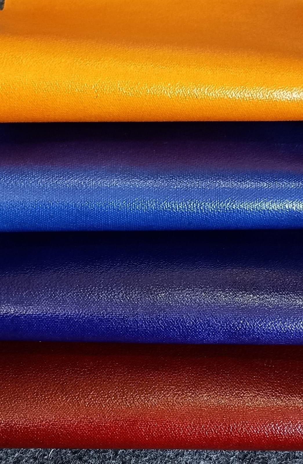 Bioleather logo on a white background with an image of four stacked rolls of vegan leather in vibrant colors: yellow, blue, purple, and red.